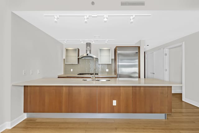 340 E Randolph St Unit 404, Chicago, IL 60601 - kitchen with wall chimney range hood, high end refrigerator, light wood finished floors, light countertops, and backsplash
