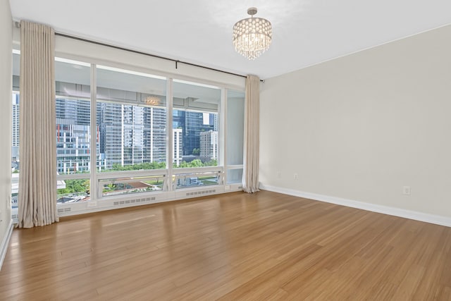 340 E Randolph St Unit 404, Chicago, IL 60601 - unfurnished room with a chandelier and wood finished floors