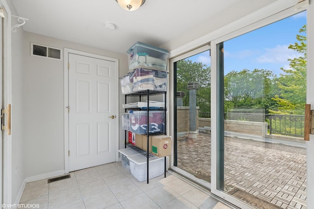 5414 S Greenwood Ave Unit 2, Chicago, IL 60615 - doorway to outside with light tile patterned floors and baseboards