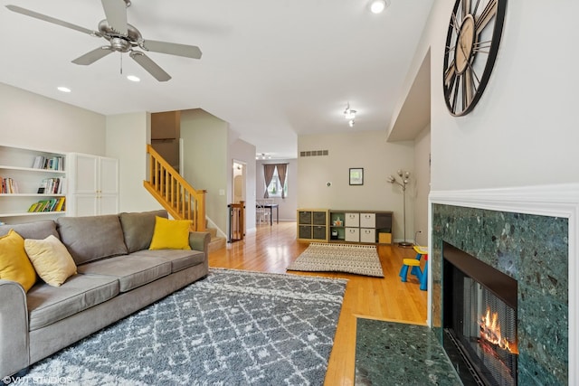 5414 S Greenwood Ave Unit 2, Chicago, IL 60615 - living room featuring stairs, a tiled fireplace, wood finished floors, a ceiling fan, and recessed lighting