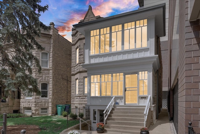 109 S Maple Ave, Oak Park, IL 60302 - back of house at dusk featuring entry steps and a balcony