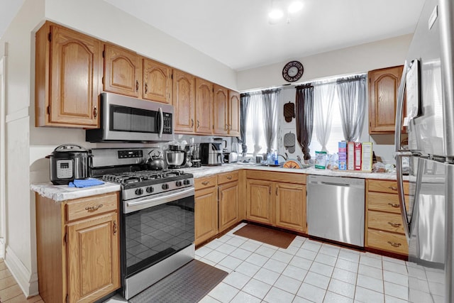 109 S Maple Ave, Oak Park, IL 60302 - kitchen with appliances with stainless steel finishes, light countertops, and light tile patterned floors