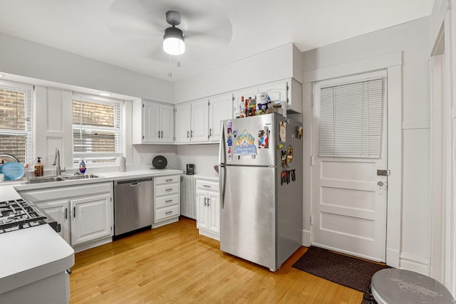 109 S Maple Ave, Oak Park, IL 60302 - kitchen featuring stainless steel appliances, light wood-style floors, white cabinetry, ceiling fan, and light countertops