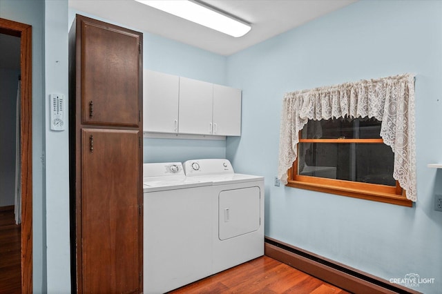 92 Maple St, Sugar Grove, IL 60554 - laundry area with washer and clothes dryer, baseboard heating, wood finished floors, and cabinet space