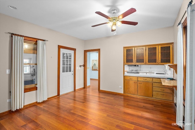 92 Maple St, Sugar Grove, IL 60554 - kitchen with light countertops, wood finished floors, a ceiling fan, and brown cabinetry