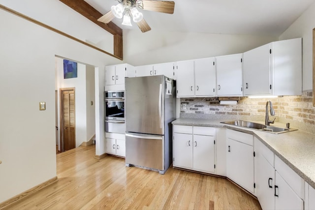 76 Brook Ln, Lindenhurst, IL 60046 - kitchen featuring appliances with stainless steel finishes, decorative backsplash, ceiling fan, light countertops, and white cabinets