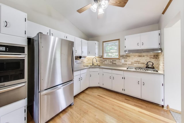 76 Brook Ln, Lindenhurst, IL 60046 - kitchen with appliances with stainless steel finishes, under cabinet range hood, a warming drawer, lofted ceiling, and decorative backsplash