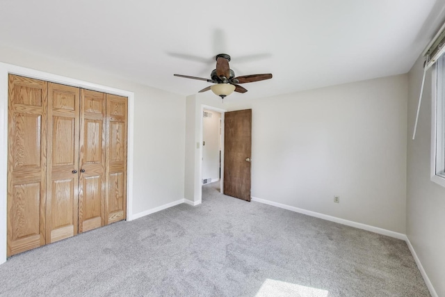 76 Brook Ln, Lindenhurst, IL 60046 - unfurnished bedroom featuring light carpet, a closet, and a ceiling fan