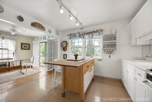 718 Liberty Ln, Lombard, IL 60148 - kitchen with wood counters, light wood-style flooring, white cabinets, and a kitchen breakfast bar