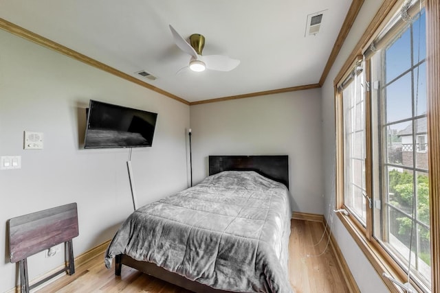 1206 Lathrop Ave, River Forest, IL 60305 - bedroom with ornamental molding, multiple windows, wood finished floors, and ceiling fan