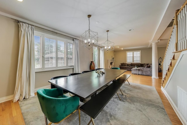 1206 Lathrop Ave, River Forest, IL 60305 - dining area featuring wood finished floors, a chandelier, stairs, recessed lighting, and decorative columns