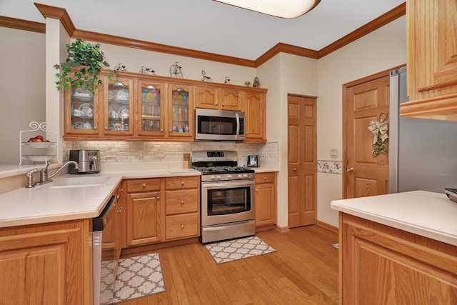 20910 W Blossom Ln, Plainfield, IL 60544 - kitchen with appliances with stainless steel finishes, decorative backsplash, crown molding, light wood-style flooring, and glass insert cabinets