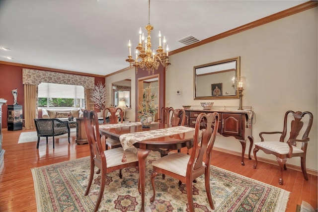 20910 W Blossom Ln, Plainfield, IL 60544 - dining space featuring crown molding, a chandelier, and light wood-style flooring