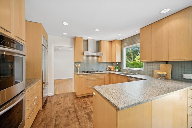 2416 Birchwood Ln, Wilmette, IL 60091 - kitchen with wall chimney exhaust hood, light brown cabinetry, appliances with stainless steel finishes, wood finished floors, and tasteful backsplash