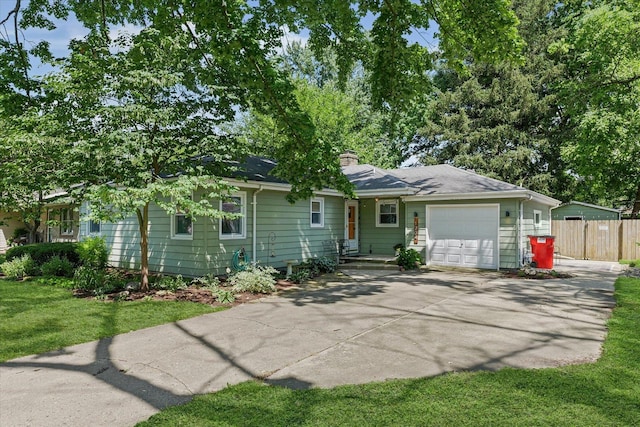 1704 Chevy Chase Dr, Champaign, IL 61821 - view of front of home featuring a garage, driveway, and a chimney