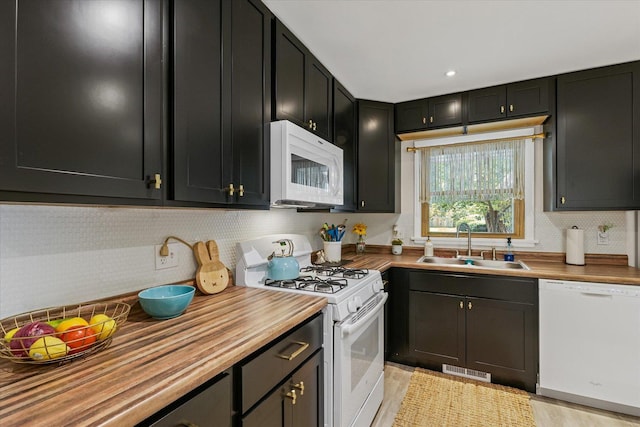 1704 Chevy Chase Dr, Champaign, IL 61821 - kitchen featuring white appliances, butcher block counters, decorative backsplash, and dark cabinetry