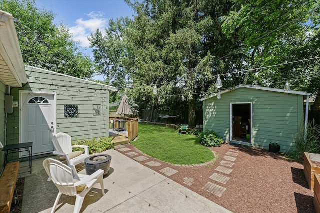 1704 Chevy Chase Dr, Champaign, IL 61821 - view of patio featuring an outdoor fire pit and an outdoor structure