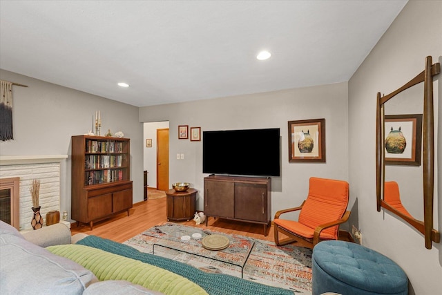 1704 Chevy Chase Dr, Champaign, IL 61821 - living area with wood finished floors, a glass covered fireplace, and recessed lighting