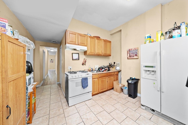 5522 S Wells St, Chicago, IL 60621 - kitchen with white appliances, under cabinet range hood, light countertops, and light tile patterned floors