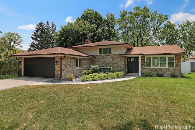 813 E Gardenia Ln, Palatine, IL 60074 - split level home with brick siding, a garage, a front yard, concrete driveway, and a chimney