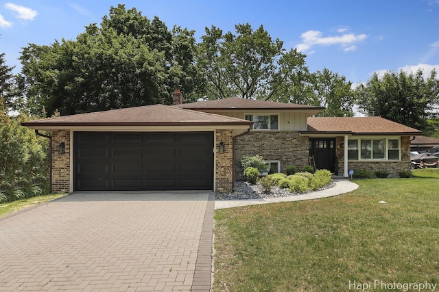 813 E Gardenia Ln, Palatine, IL 60074 - tri-level home featuring brick siding, an attached garage, decorative driveway, a front yard, and a chimney
