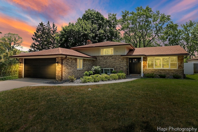 813 E Gardenia Ln, Palatine, IL 60074 - split level home featuring brick siding, an attached garage, concrete driveway, and a lawn