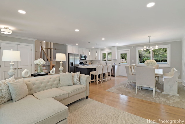 813 E Gardenia Ln, Palatine, IL 60074 - living room with stairway, light wood-style flooring, recessed lighting, crown molding, and a chandelier