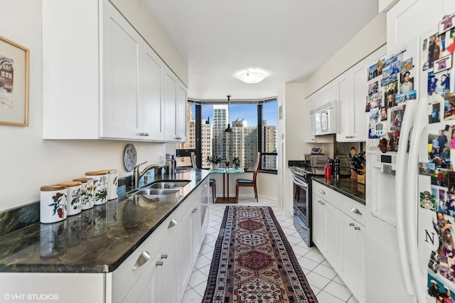 1410 N State Pkwy Unit 18B, Chicago, IL 60610 - kitchen with white appliances, light tile patterned floors, and white cabinetry