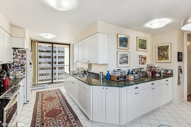 1410 N State Pkwy Unit 18B, Chicago, IL 60610 - kitchen with stainless steel stove, white dishwasher, expansive windows, white cabinetry, and light tile patterned floors