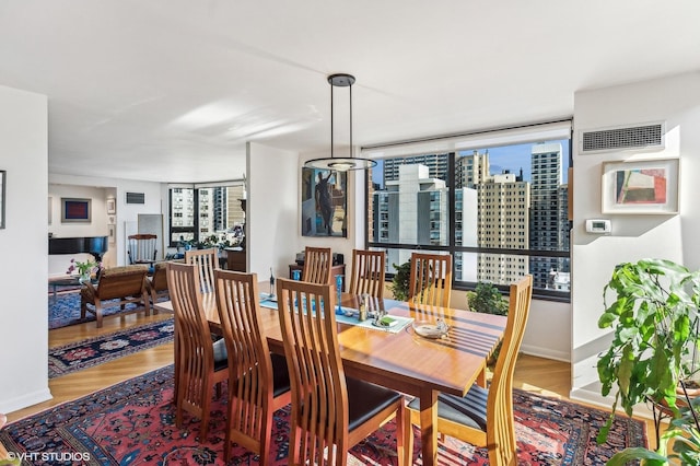 1410 N State Pkwy Unit 18B, Chicago, IL 60610 - dining area featuring wood finished floors and a city view