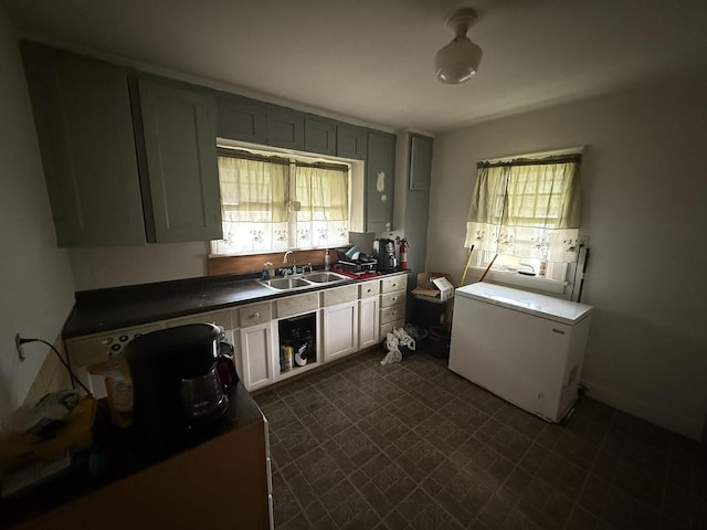 507 W 12th St, Sterling, IL 61081 - kitchen with refrigerator, dark floors, and dark countertops