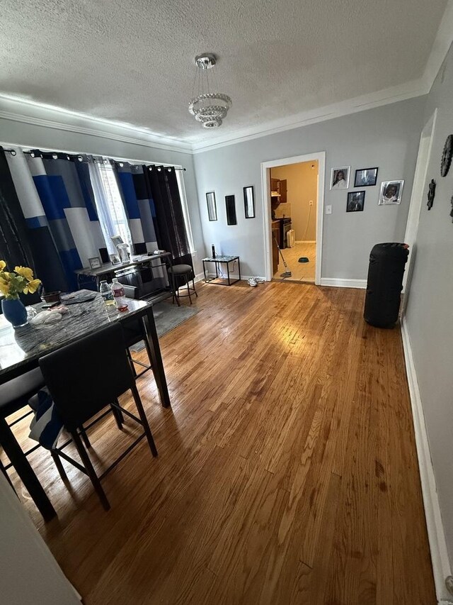 7544 S Sangamon St, Chicago, IL 60620 - dining area with crown molding, a textured ceiling, and light wood-type flooring