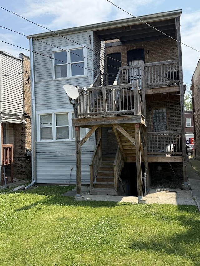 7544 S Sangamon St, Chicago, IL 60620 - back of house featuring brick siding, a lawn, stairs, and a wooden deck