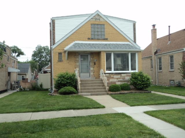7341 W 56th Pl, Summit, IL 60501 - view of front of house featuring a front yard, a shingled roof, and brick siding