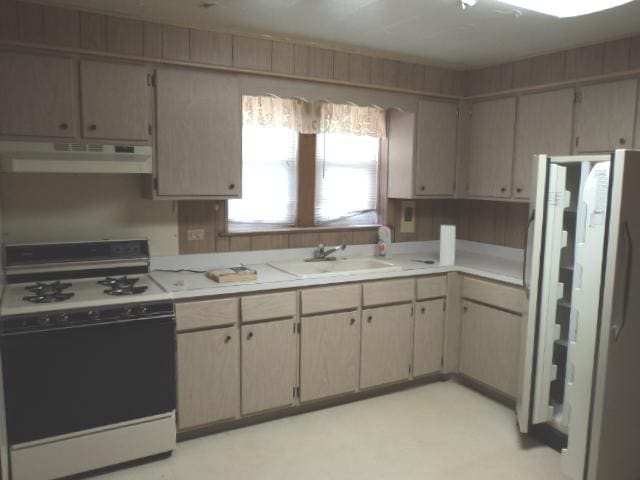 7341 W 56th Pl, Summit, IL 60501 - kitchen featuring stove, under cabinet range hood, freestanding refrigerator, and light countertops