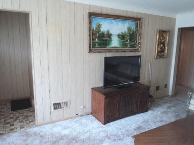 7341 W 56th Pl, Summit, IL 60501 - unfurnished living room with wooden walls, carpet flooring, and crown molding