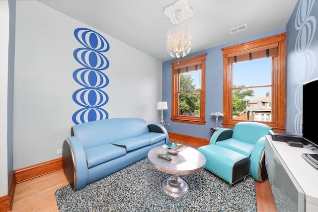 2347 Clarence Ave, Berwyn, IL 60402 - living room with light wood finished floors and a chandelier