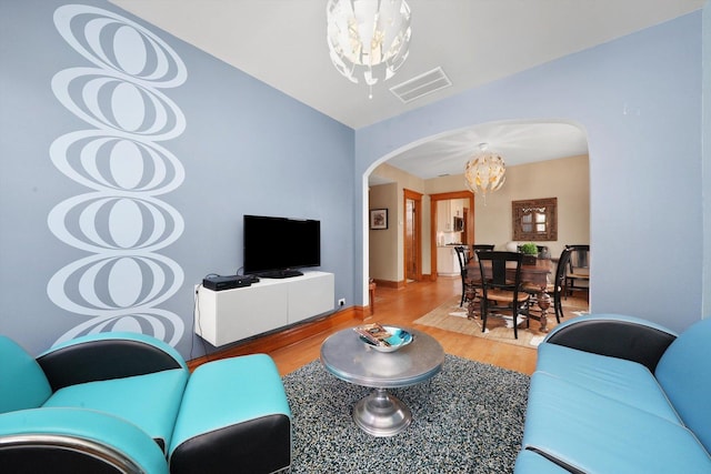 2347 Clarence Ave, Berwyn, IL 60402 - living room with a chandelier, arched walkways, and wood finished floors