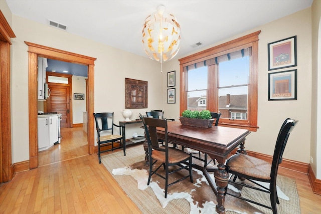 2347 Clarence Ave, Berwyn, IL 60402 - dining space featuring light wood-type flooring and a chandelier