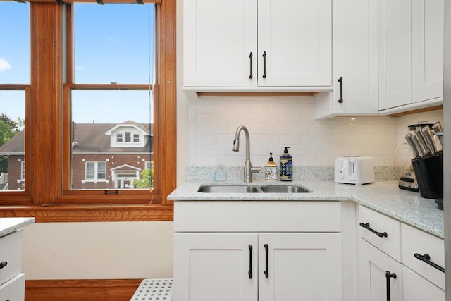 2347 Clarence Ave, Berwyn, IL 60402 - kitchen with decorative backsplash, white cabinetry, and light stone counters
