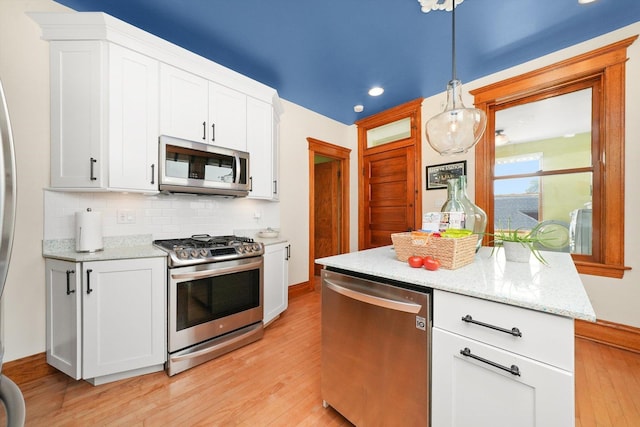 2347 Clarence Ave, Berwyn, IL 60402 - kitchen featuring appliances with stainless steel finishes, light wood-type flooring, tasteful backsplash, white cabinets, and recessed lighting