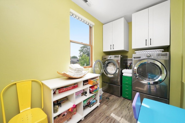 2347 Clarence Ave, Berwyn, IL 60402 - laundry room featuring cabinet space, washing machine and clothes dryer, and light wood-style floors