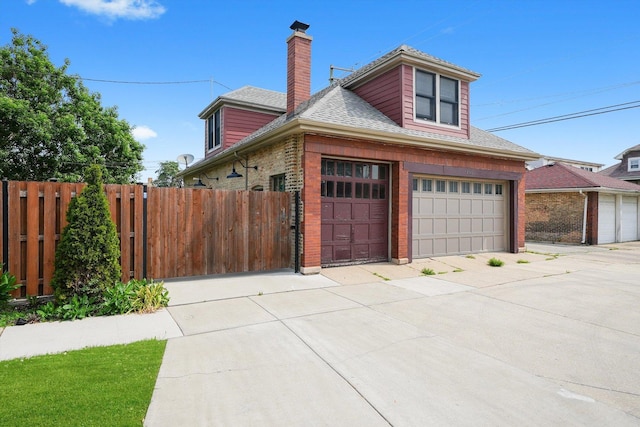 2347 Clarence Ave, Berwyn, IL 60402 - view of front of house featuring a garage, a chimney, a shingled roof, brick siding, and driveway