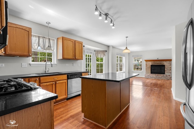 2008 Crosswind Dr, Plainfield, IL 60586 - kitchen featuring stainless steel appliances, plenty of natural light, dark countertops, and a brick fireplace