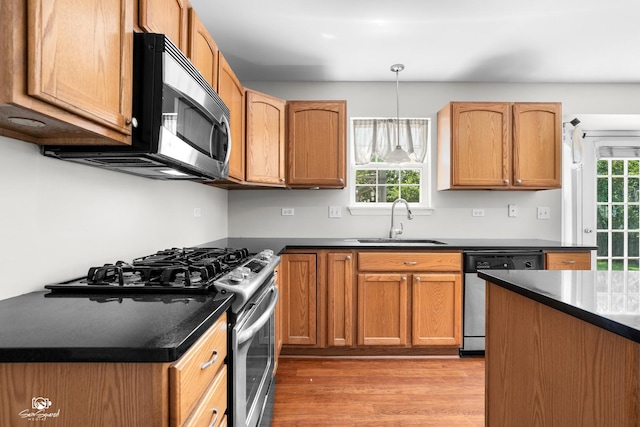 2008 Crosswind Dr, Plainfield, IL 60586 - kitchen featuring appliances with stainless steel finishes, light wood-style flooring, dark countertops, and pendant lighting
