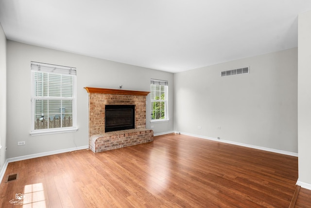 2008 Crosswind Dr, Plainfield, IL 60586 - unfurnished living room featuring wood finished floors and a brick fireplace