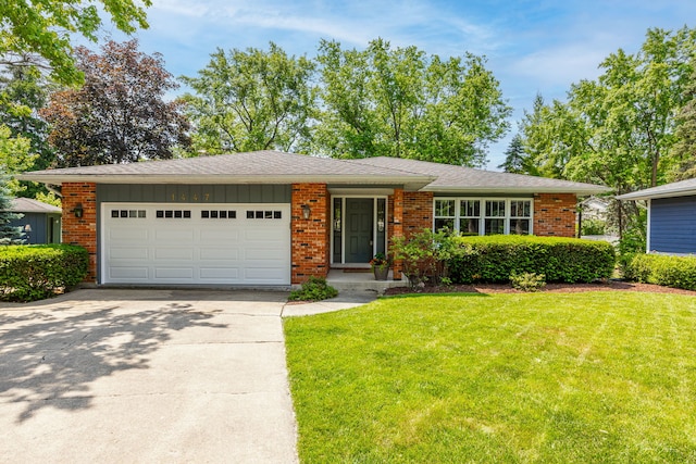 1447 Hillcrest Rd, Downers Grove, IL 60516 - view of front of home with concrete driveway, a front lawn, a garage, board and batten siding, and brick siding
