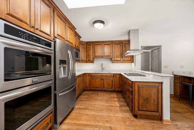 1447 Hillcrest Rd, Downers Grove, IL 60516 - kitchen with stainless steel appliances, island exhaust hood, brown cabinetry, a peninsula, and light wood-type flooring