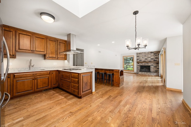 1447 Hillcrest Rd, Downers Grove, IL 60516 - kitchen featuring extractor fan, a peninsula, appliances with stainless steel finishes, brown cabinets, and open floor plan