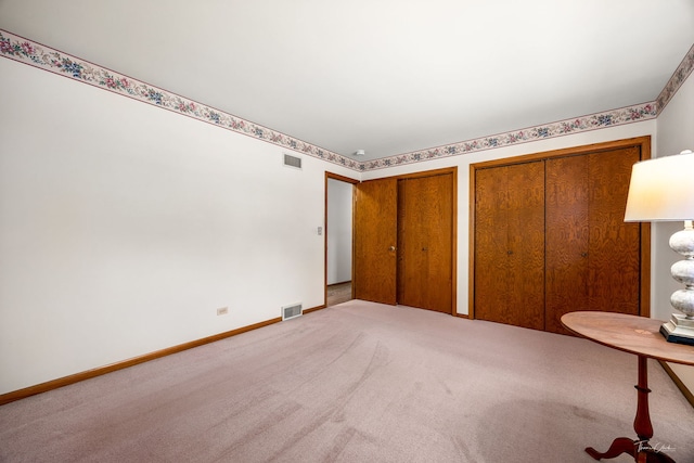 1447 Hillcrest Rd, Downers Grove, IL 60516 - unfurnished bedroom featuring two closets and carpet